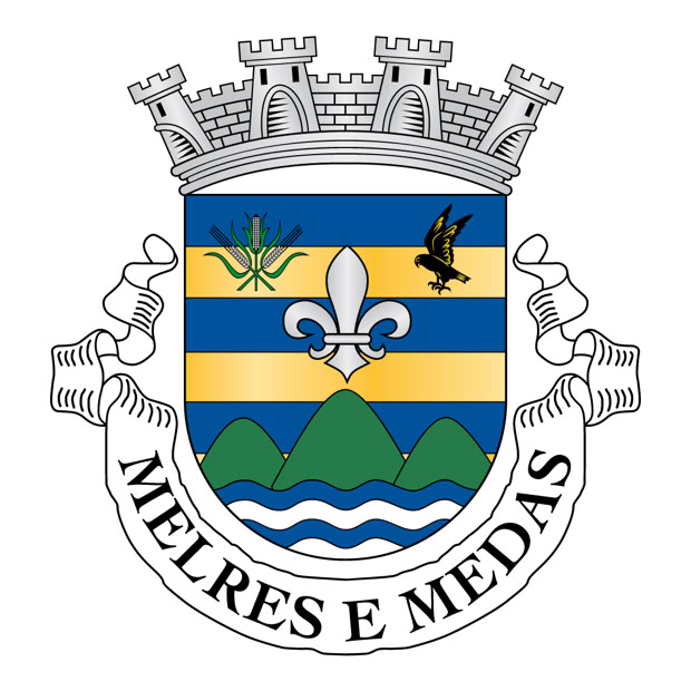 Two happy store owners smiling while wearing aprons in a local grocery store.